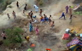 Pakistani Villagers Chase Supplies                                                                  