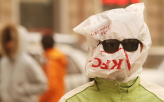 Resourceful man protects himself from a sandstorm                                                   